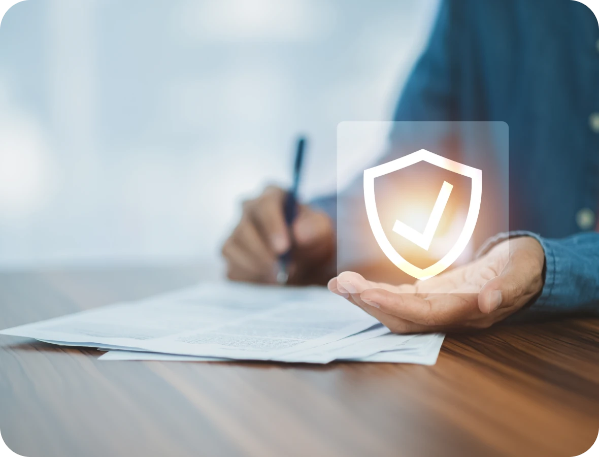 Person holding shield icon over documents.