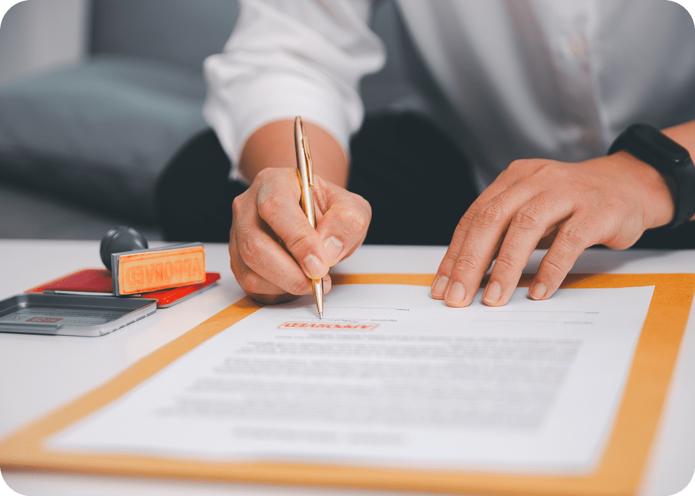 Signing a document with a pen.