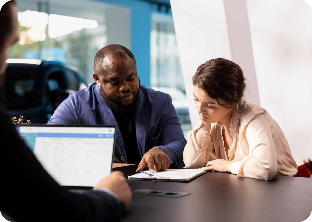 People discussing documents in an office meeting.